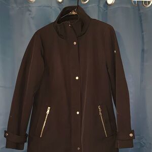 Black, large winter jacket. Zipper and button down. Zipper pockets. Warm lining.